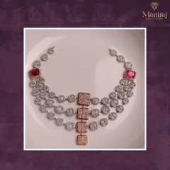 Unveiling a true work of art. This three-layered diamond necklace, accented with rose gold elements and bold ruby squares, is a perfect blend of modern design and classic luxury.