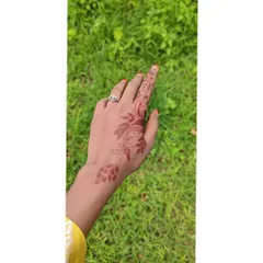 A simple and sweet design with a small floral vine that trails from the wrist to the index finger.
