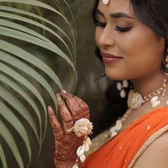 A close-up of the beautiful Haldi look. The warm, shimmery eyeshadow and glowing skin are perfect for this sunny, outdoor ceremony.