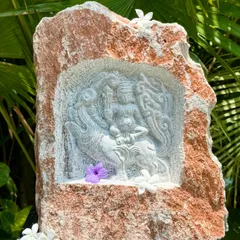 This niche carving in natural rock depicts a mythical being, reflecting the rich spiritual heritage of South India. These pieces add a touch of artistry and devotion to any garden space.