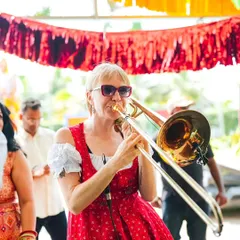 A live marching band, complete with a trombonist, weaves through the crowd, creating a dynamic and interactive musical experience. This is a huge step up from a stationary stage performance.