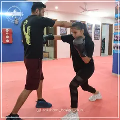 Here is one of our female trainees practicing her jab with a coach. We focus on proper technique to ensure every punch is both powerful and safe, helping you master the fundamentals of self-defense.