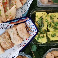A glimpse of a high tea spread we catered, featuring our fresh, spongy Khaman Dhokla, savoury baked puffs, and other bite-sized Indian snacks.