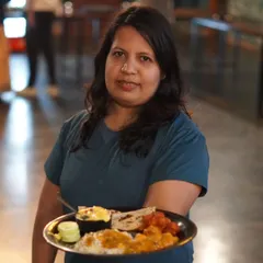A happy guest showing off her plate from our unlimited buffet. We pride ourselves on serving delicious and satisfying meals.