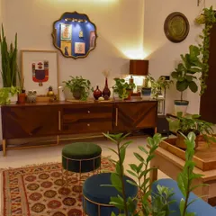 This view showcases the console table, which also serves as a plant stand. Using furniture to display plants is a great way to integrate them into your decor.