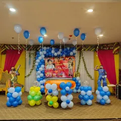Here is a cricket-themed birthday party setup I did in a banquet hall. The decoration includes a blue and white balloon arch over the main table, themed cutouts of famous cricketers, and balloon pillars. I can customize any sports theme for your kid's birthday.