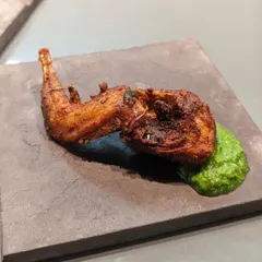 This is Kada is Kada, or deep-fried quail marinated in dry spices. It's a delicacy in Kerala and makes for a unique and flavorful appetizer. I serve it here with a fresh green chutney.