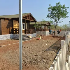 The farmhouse project in progress. The ground is ready, and my team is beginning to shape the landscape around the newly built cabins.