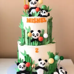 A playful two-tiered panda cake, with cute pandas climbing bamboo stalks and playing with balloons. This is one of my cutest designs!