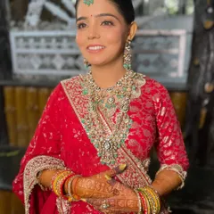 A full view of the stunning red lehenga, with makeup kept soft and classic to match.