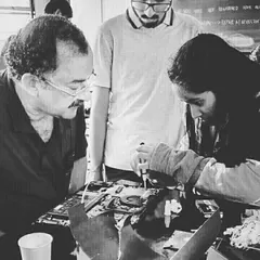 A focused moment between a mentor and a student during a laptop repair session. We believe in personalized guidance to help each child build confidence and master complex tasks like diagnosing and fixing electronic devices.