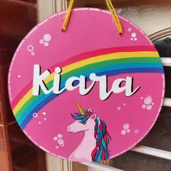 A bright and cheerful unicorn nameplate for Kiara. The design features a hand-painted rainbow and unicorn on a vibrant pink background, perfect for adding a splash of color and magic to a child's door.
