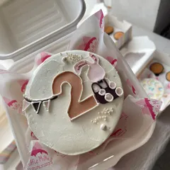 A sweet bento cake for a second birthday. The design features the number two and a little bunny, perfect for a toddler's celebration.