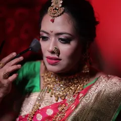 Here, I am demonstrating the correct way to apply finishing powder. This is a crucial step for setting makeup, controlling shine, and ensuring a bride's look stays fresh for hours.