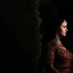 A moody and elegant bridal portrait from a reception. The dramatic side lighting creates a sophisticated and timeless look.