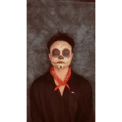 A colorful sugar skull makeup inspired by the characters from Coco. I use high-pigment paints to create the vibrant red details around the eyes, contrasting with the skeletal structure.