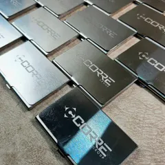 A closer look at the engraved metal card holders, showing the clean and precise logo application.