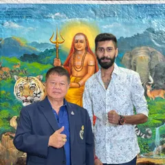 With my godfather, Grand Master Woody, in front of a painting of a Hindu sage. My fighting philosophy is a blend of Thai martial tradition and my own deep-rooted faith.