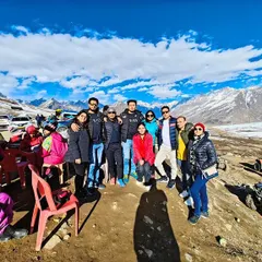 Our group standing together against the stunning panorama of snow and mountains at Rohtang Pass. The crisp air and magnificent views filled us all with incredible energy.