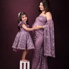 A mother and daughter in matching purple lace gowns. These "mommy and me" style shoots are a wonderful way to celebrate the bond you share.