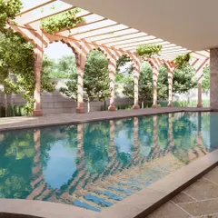 The haveli's swimming pool is a tranquil oasis. The design features a pergola supported by traditional stone arches, creating a play of light and shadow on the water that connects the leisure space with the building's historic character.