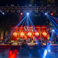 The stage for a soulful Sufi performance. I created a backdrop of red velvet and golden arches inset with chandeliers, setting a perfectly mystical and grand vibe for the sangeet night.