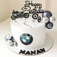A sleek and stylish BMW-themed cake for a car enthusiast. The design features the iconic logo, a motorcycle topper, and silver and black accents for a modern look.