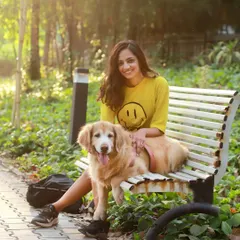 A sunny day on a park bench with Aaby the golden retriever and her person. This photo radiates the warmth and happiness pets bring into our lives.