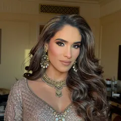 A close-up of this stunning Roka makeup. The bold smokey eye and perfectly sculpted brows are paired with voluminous curls for a glamorous start to the wedding festivities.