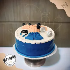 A cake that's fit for a fitness enthusiast. This gym-themed cake features fondant dumbbells, a skipping rope, and workout clothes, perfect for a gym freak's birthday.
