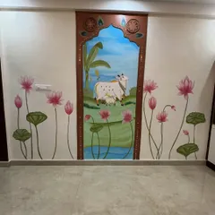 A full view of a unique Pichwai-inspired wall combining painting, lippan art with ropes, and textured concrete. The central scene is framed like a traditional window, with lotuses blooming on either side.