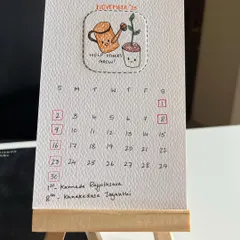 Here’s a close-up of my 2025 hand-drawn desk calendar. Each month features a unique, punny doodle on eco-friendly, recycled paper, and it comes with this cute little wooden easel to sit perfectly on your desk.