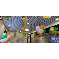 For the Independence Day celebration at DQS, I decorated the ceiling with tricolor balloon clusters and hanging paper fan decorations. This approach adds festivity to the entire room from above.