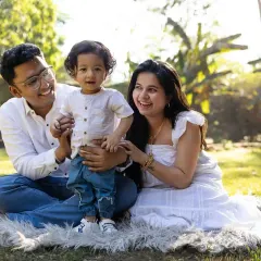 Love and laughter under the open sky. This candid family portrait captures a beautiful, unposed moment of connection between parents and their little one.