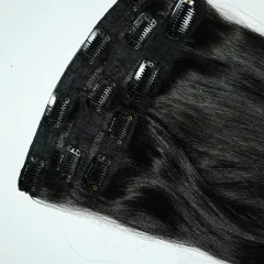 It's as easy as clip, blend, and slay. This close-up shows the sturdy clips on a weft of my jet-black extensions, ready to give you a glamorous look in minutes.