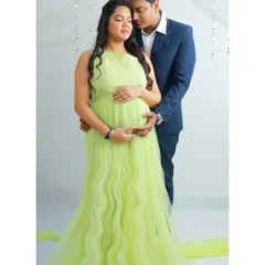 The quiet, tender moments between partners are so precious. In this shot, I captured the gentle connection between the couple, her in a vibrant lime-green gown, as they share a moment of anticipation for their baby's arrival.
