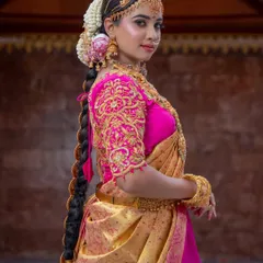 The complete bridal look from the side, showcasing the detailed embroidery on the blouse and the traditional long braid. I ensure every element, from the makeup to the hair, works together for a cohesive and beautiful result.