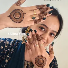 A smiling client showing off her chic and modern mandala designs.