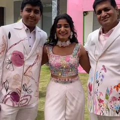 A family portrait that fills my heart with joy. I designed and painted each of these outfits, creating a cohesive floral theme that connected them all. Seeing my art become a part of their family's celebration is the greatest reward.