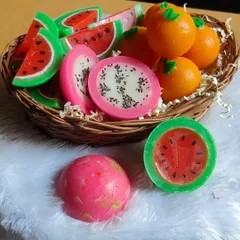 A basket full of my handmade fruit soaps. I create realistic-looking watermelon, dragon fruit, and orange soaps that are as fun to use as they are beautiful.