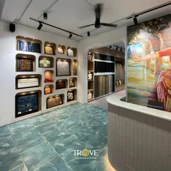 The reception area of my Whitefield experience center, where luxury meets variety. The space features a custom mural, a wall of unique tile samples in alcoves, and beautiful floor tiles, setting the stage for a creative and inspiring tile selection journey.