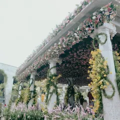 The mandap for Nithya and Payton's wedding in Nandi Hills was a garden paradise. We covered the structure in a dense canopy of pink blooms and wrapped the pillars in spiraling yellow flowers to create a vibrant, joyful space for their ceremony.