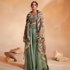 Our Adoree Cape Set balances modern prints with traditional layering. This three-piece ensemble includes a hand-adorned bustier, swirl-worthy flared pants, and an alluring oversized cape in a custom print, perfect for a statement-making entrance.