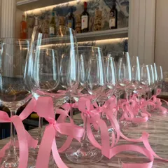 I added simple pink ribbons to the wine glasses at the bar. This small touch helps carry the theme throughout the entire venue and adds a pop of color.