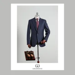 This single-breasted navy suit is a cornerstone of any professional wardrobe. Its versatility and timeless appeal are enhanced by our bespoke fit and quality fabric.