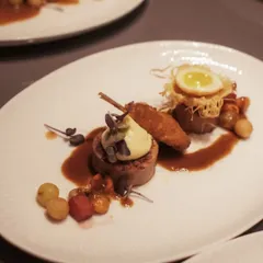 A playful and sophisticated dish I call 'Teetar ke Do Aage Teetar'. It features a quail roulade stuffed with bacon and chestnut, served with a perfectly fried quail egg and a rich chorizo jus.