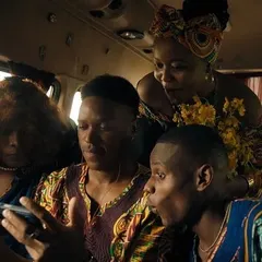 A still from the SanDisk ad, where a family gathers around a phone. I used colorful, patterned African textiles to create a sense of warmth, culture, and connection.