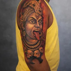 Jai Maa Kali! This tattoo captures the fierce and powerful form of the goddess. I used a mix of black and grey with fiery red and orange tones in the background to represent her divine rage and protective energy. The details in her expression and the garland of skulls make this a truly impactful piece.