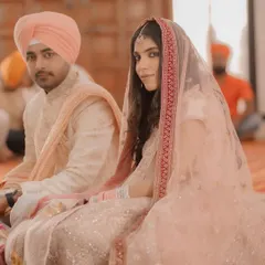 A beautiful portrait of the couple during their Sikh wedding ceremony. The bride glances towards the camera, her delicate veil and pastel lehenga looking ethereal.