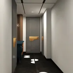 This hallway features a modern door with a unique, oversized brass handle and striking black flooring with white marble inlays.